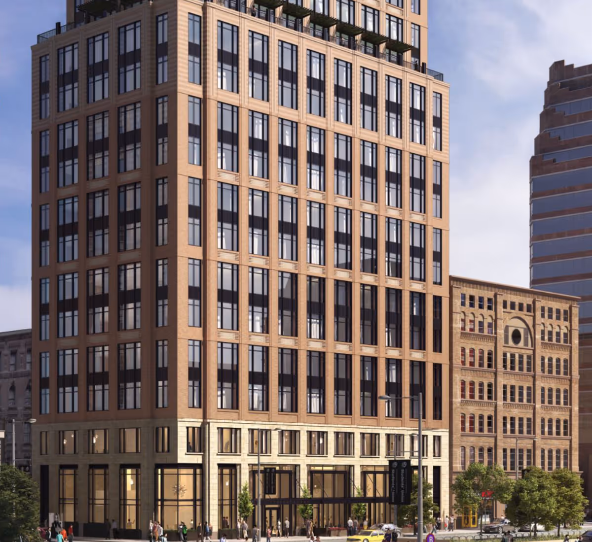 Street-level view of a multi-story brick and glass high-rise with large windows and people and cars at the sidewalk.