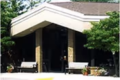 Front entrance of Edison Christian Assisted Living with benches and trees